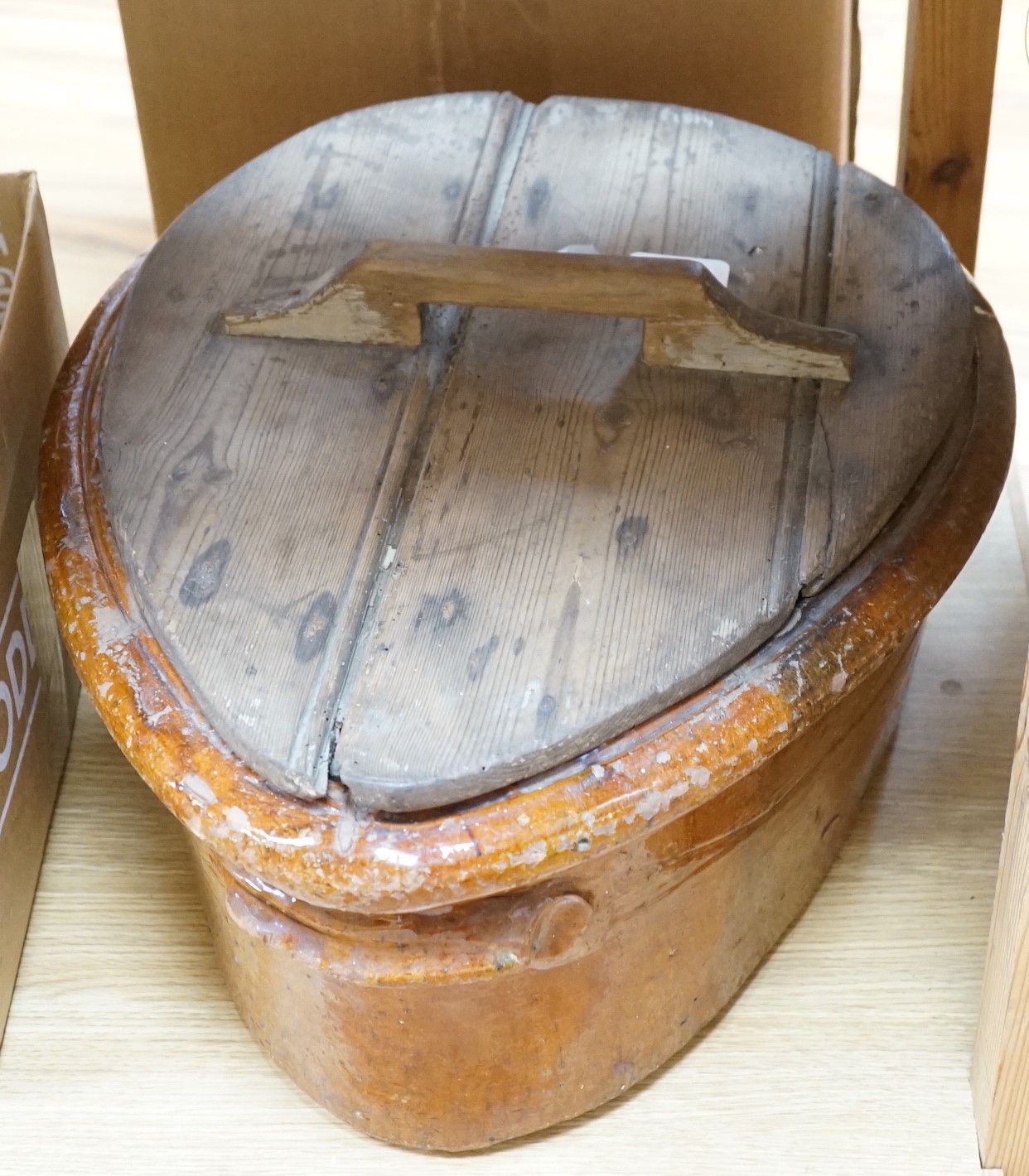 A 19th Century French terracotta ham-smoking pot with original wooden lid